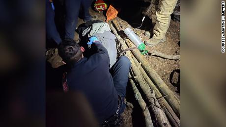 Bystanders used a belt, shoelaces and branches to build a makeshift stretcher. 