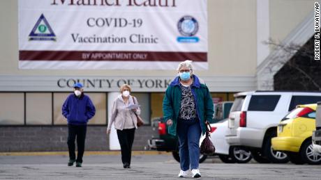 Senior citizens leave a vaccination site at a former department store in Sanford.