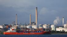 The MV Epic St George LNG (liquid natural gas tanker) passes the Esso Oil refinery in Fawley, near Southampton, southern England on October 4, 2021. (Photo by Adrian DENNIS / AFP) (Photo by ADRIAN DENNIS/AFP via Getty Images)