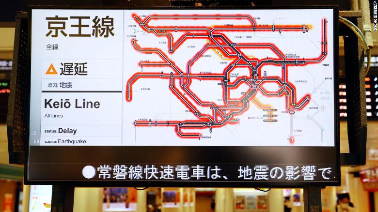 The status of the train services delayed by the earthquake are seen on a monitor at JR Tokyo station.
