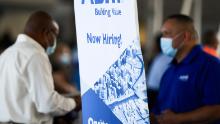 ABM Industries Inc. hiring announcement is posted as people attend a job fair for employment with SoFi Stadium and Los Angeles International Airport employers, at SoFi Stadium on September 9, 2021, in Inglewood, California. 