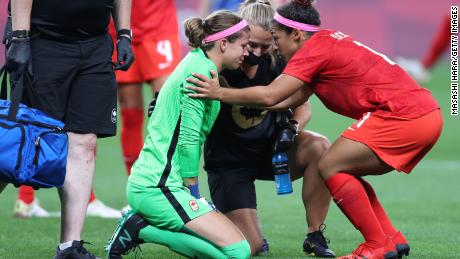 Labbe receives medical treatment during the match against Japan.