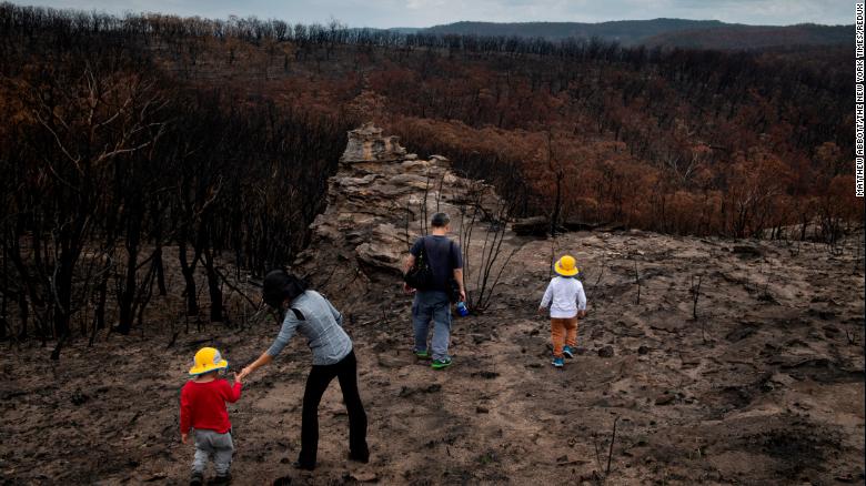 A family from Sydney, Australia, visiting an area devastated by bush fires in the New South Wales region of Australia on Jan. 28, 2020. 