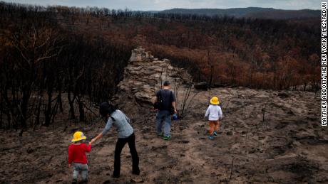A family from Sydney, Australia, visiting an area devastated by bush fires in the New South Wales region of Australia on Jan. 28, 2020. 