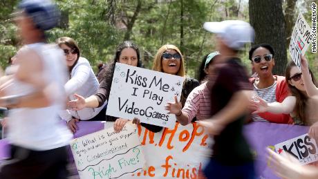 Boston Marathon spectators at Wellesley College hold &quot;kiss me&quot; signs during the 2014 race.