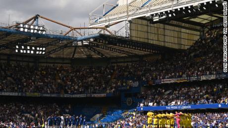 Crystal Palace (R) and Chelsea players observe a minute's silence for those who have contracted COVID-19 ahead of an English Premier League football match between the teams at Stamford Bridge in London on August 14, 2021.