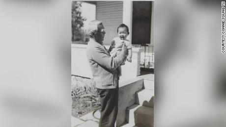 Young Wah Gok holds his granddaughter Connie Young Yu.