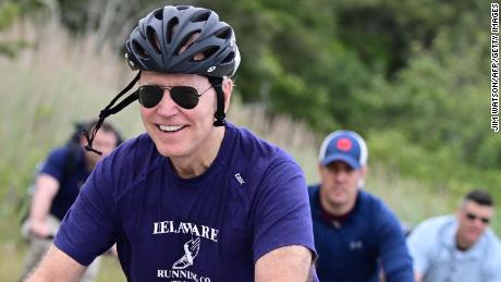 US President Joe Biden rides his bicycle in Cape Henlopen State Park on June 3, 2021, in Lewes, Delaware.