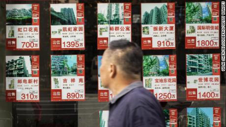 Advertisements for apartments for sale at a real estate office in Shanghai, China, on Monday, 30 August 2021. 