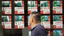 Listings of apartments for sale are displayed at a real estate office in Shanghai, China, on Monday, August 30, 2021. 