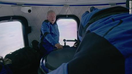 William Shatner (left) and the NS-18 crew are shown floating inside the Blue Origin space capsule.