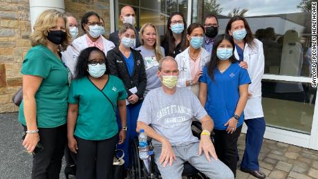 Robbie Walker, his wife Susan (in a gray shirt) and members of the ECMO team at St. Francis Hospital gather Wednesday to celebrate Walker's release from the Guylod Special Health Service Center.  Angela Sakal (South) is Walker's chief perfumer in St. Francis.