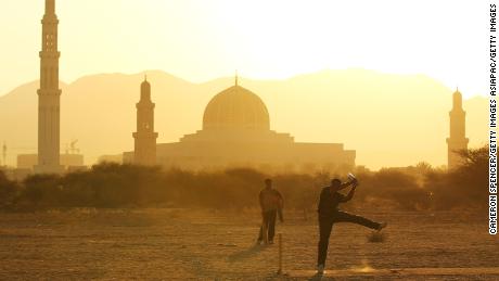 Locals play a cricket match in Muscat in December 2010.