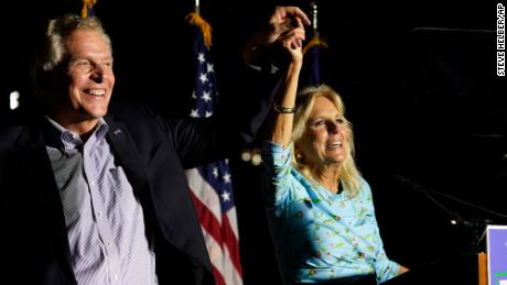 First lady Jill Biden laughs with Democratic gubernatorial candidate Terry McAuliffe during a rally in Richmond, Virginia, on October 15, 2021. 