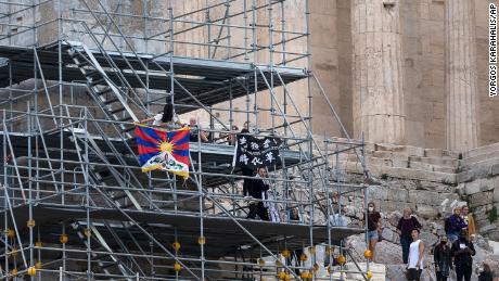 Protesters also raised a Tibetan flag and a banner from scaffolding at the Acropolis hill, in Athens, Greece, on October 17.