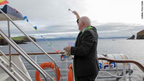 Dingle parish priest Michael Moynihan blesses the boat and its passengers with holy water.