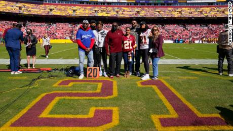 Members of the late Sean Taylor&#39;s family gather on the field as the Washington Football Team retire his number during a ceremony before the start of an NFL football game against the Kansas City Chiefs, Sunday, Oct. 17, 2021, in Landover, Md.