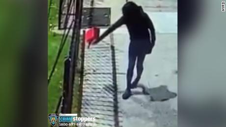 Surveillance video shows a woman pouring gasoline outside of Yashiva of Flatbush on October 14, 2021. 