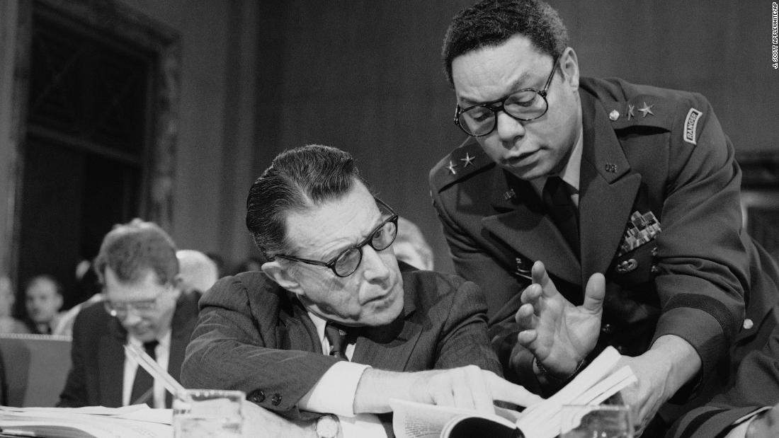 Powell confers with US Defense Secretary Casper Weinberger during a Senate committee meeting in Washington in 1985. Powell stayed in the Army after returning home from Vietnam, attending the National War College and rising in leadership. He was promoted to brigadier general in 1979, and he became a senior military assistant to Weinberger in 1983.