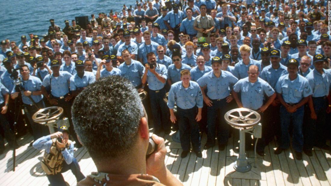 Powell addresses the crew of the USS Wisconsin during Operation Desert Shield in 1990.