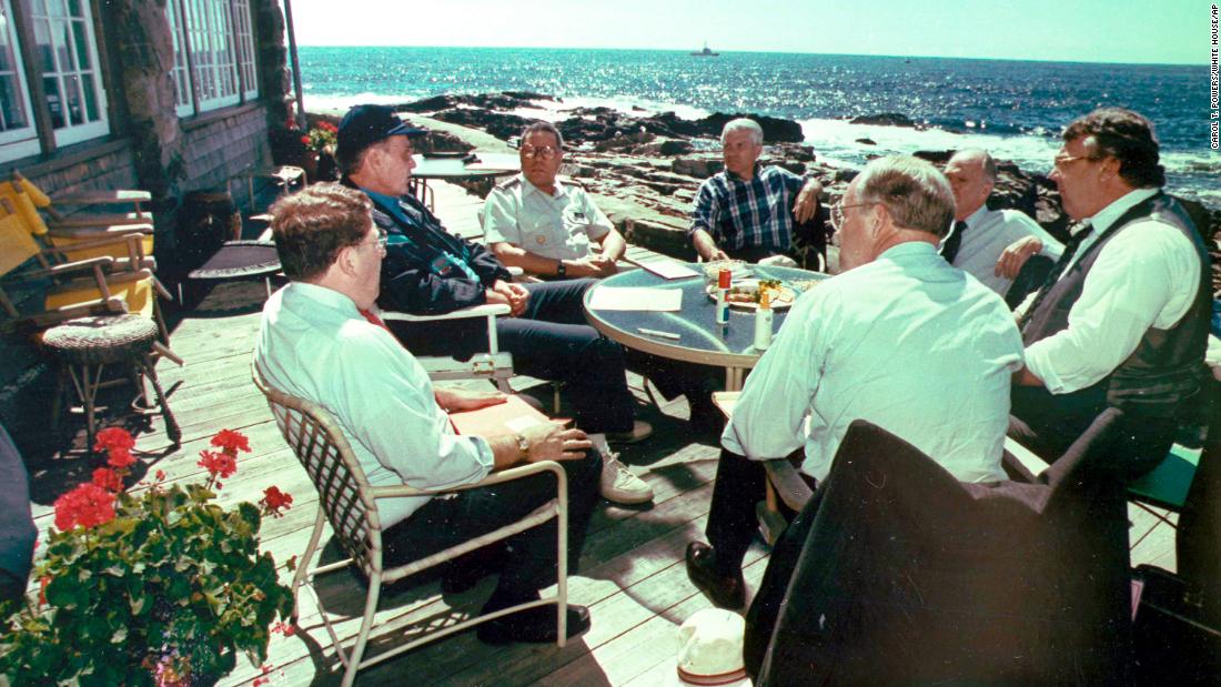 Powell joins President George H.W. Bush and other key advisers at the President&#39;s summer home near Kennebunkport, Maine, in 1990. Bush is on the left in the blue hat.