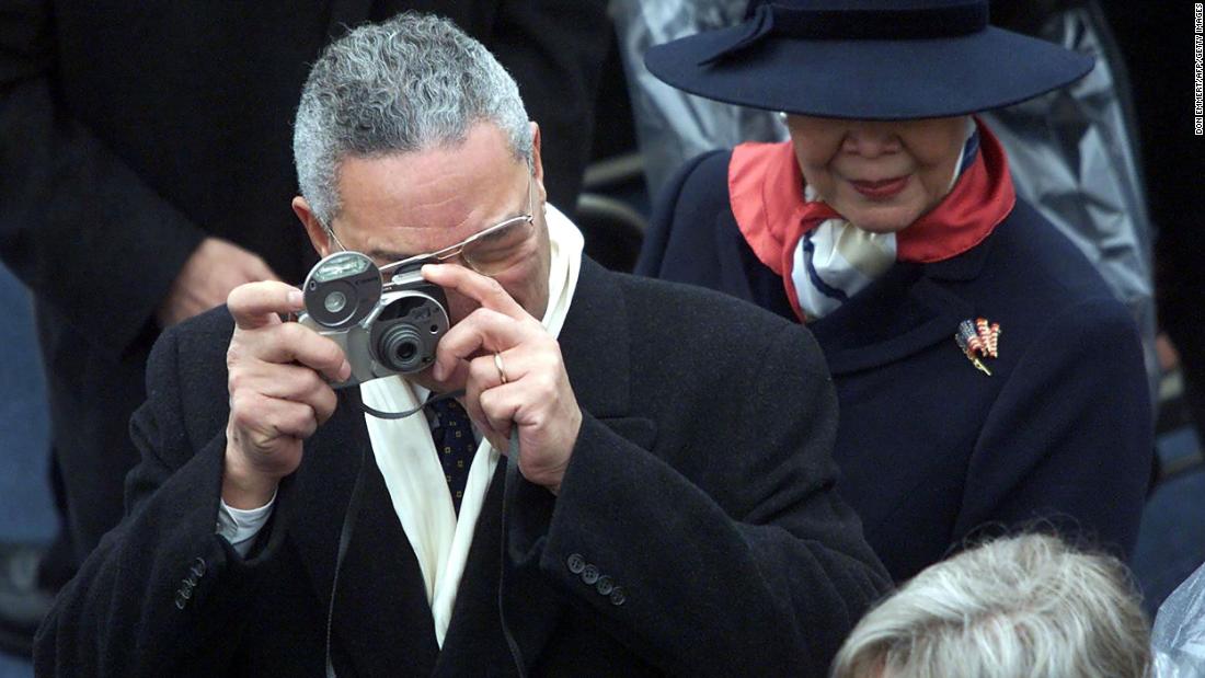 Powell takes photos beside his wife, Alma, at Bush's inauguration in 2001.