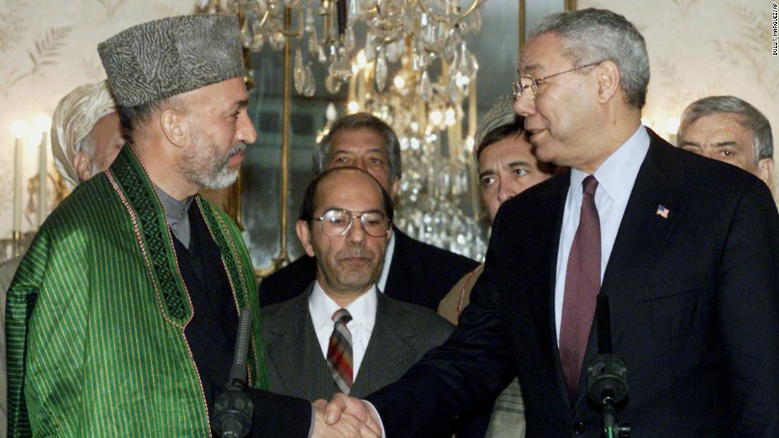 Powell shakes hands with Afghan Prime Minister Hamid Karzai in 2002. It was the first time a US secretary of state had visited Afghanistan since 1976.