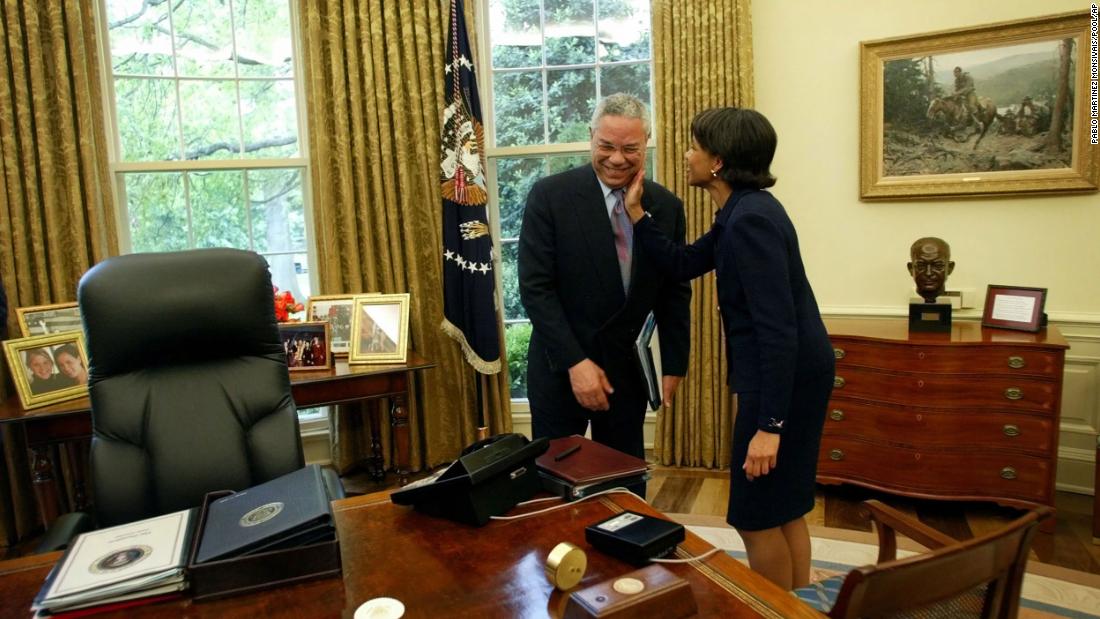 Powell receives a pat on the cheek from national security adviser Condoleezza Rice during an Oval Office meeting in 2002. In 2005, Rice would succeed Powell as secretary of state.