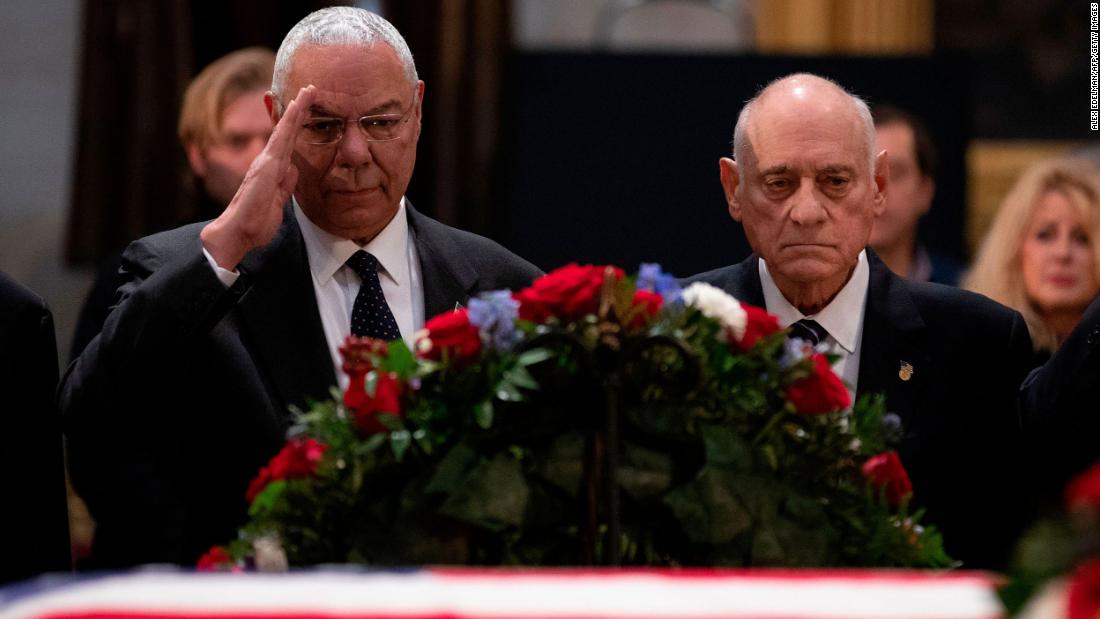 Powell salutes as he and other former military commanders pay their last respects to former President George H.W. Bush in 2018.