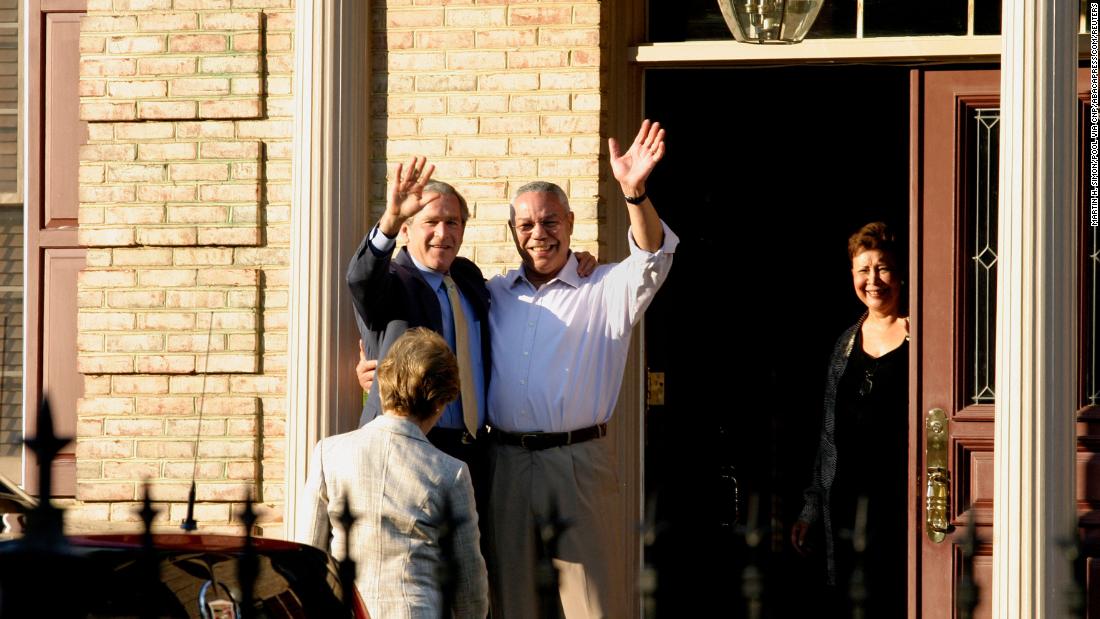 Bush and Powell wave from Powell&#39;s home in McLean, Virginia, in 2005.