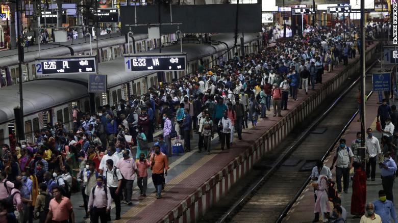 Commuters wait for local trains during peak hours at Chhatrapati Shivaji Maharaj Terminus in Mumbai on September 30, 2021. 