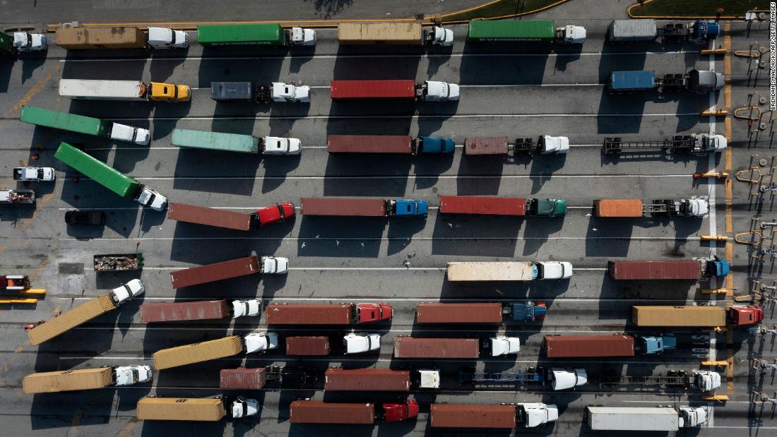 Trucks transport cargo containers on October 14 at the Port of Baltimore in Maryland.