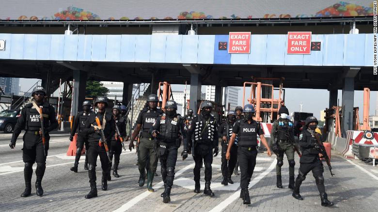 Police officers arrive at the scene of protest commemorating the one-year anniversary of #EndSARS, a movement against police brutality, at the Lekki toll gate in Lagos, on October 20, 2021. 