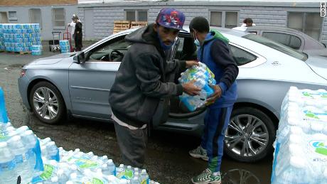 Residents of Benton Harbor pick up bottled water distributed by the state.