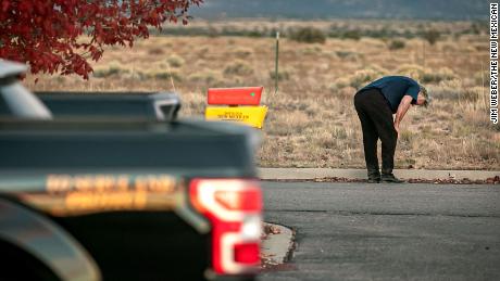 A distraught Alec Baldwin lingers in the parking lot outside the Santa Fe County sheriff&#39;s offices after being questioned Thursday about a shooting on a local movie set.