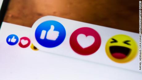 Close-up of Facebook reaction icons shown on a smartphone.