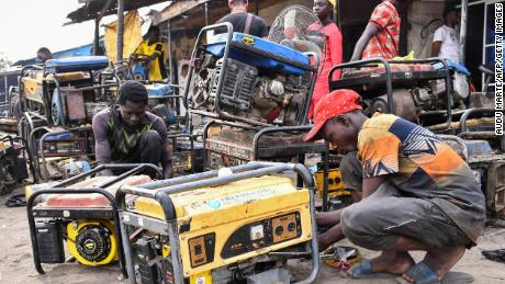 Young men work on generators at a workshop in Maiduguri in Nigeria&#39;s northeast.