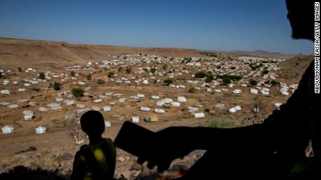 A Tigrayan man looks for cellular service on a mountain overlooking Um Rakuba refugee camp in eastern Sudan in January.
