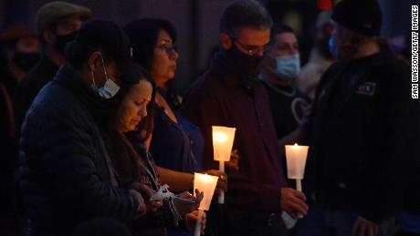 People hold candles as they attend a vigil held in honor of cinematographer Halyna Hutchins at Albuquerque Civic Plaza on October 23 in Albuquerque, New Mexico. 