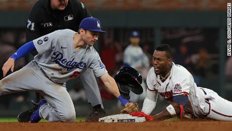Jorge Soler of the Atlanta Braves beats a tag at second base by Trea Turner of the Los Angeles Dodgers during the eighth inning of Game Six of the National League Championship Series at Truist Park on October 23, 2021 in Atlanta, Georgia.