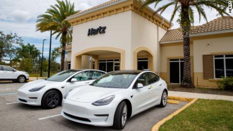 Tesla Model 3s are parked at a Hertz location.