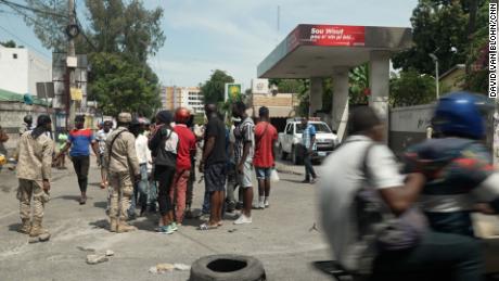 Crowd forms at a gas station in Port-au-Prince.