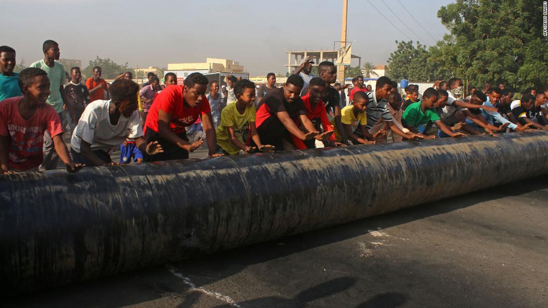 People erect barricades in Khartoum as they protest against the coup on October 25.