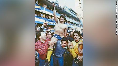Maradona, being carried by fans after winning the 1981 local championship with Boca Juniors at La Bombonera stadium in Buenos Aires.