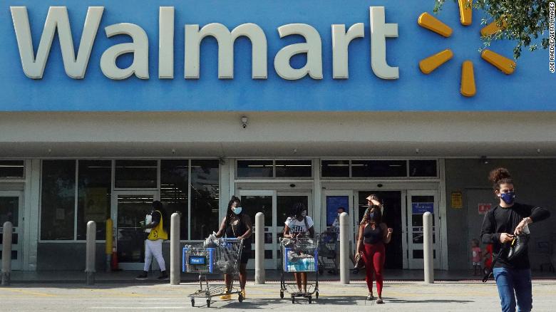 HALLANDALE BEACH, FLORIDA - MAY 18: People wearing protective masks walk from a Walmart store on May 18, 2021 in Hallandale Beach, Florida. Walmart announced that customers who are fully vaccinated against Covid-19 will not need to wear a mask in its stores, unless one is required by state or local laws. The announcement came after the Centers for Disease Control and Prevention said that fully vaccinated people do not need to wear a mask or stay 6 feet apart from others in most cases, whether indoors or outdoors. (Photo by Joe Raedle/Getty Images)