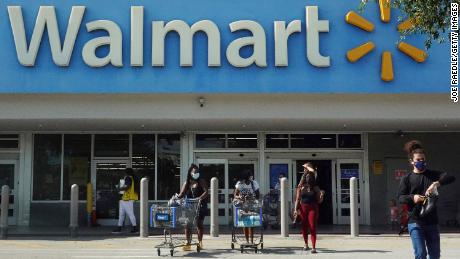 HALLANDALE BEACH, FLORIDA - MAY 18: People wearing protective masks walk from a Walmart store on May 18, 2021 in Hallandale Beach, Florida. Walmart announced that customers who are fully vaccinated against Covid-19 will not need to wear a mask in its stores, unless one is required by state or local laws. The announcement came after the Centers for Disease Control and Prevention said that fully vaccinated people do not need to wear a mask or stay 6 feet apart from others in most cases, whether indoors or outdoors. (Photo by Joe Raedle/Getty Images)