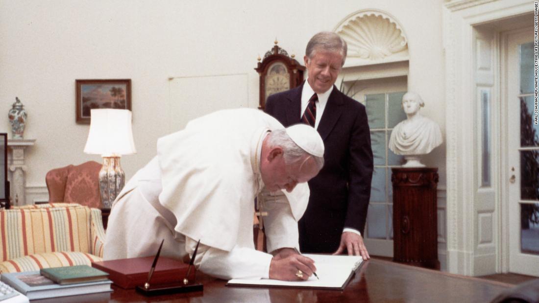 President Jimmy Carter watches Pope John Paul II sign the White House guest book in 1979. He was the first Pope to visit the White House.