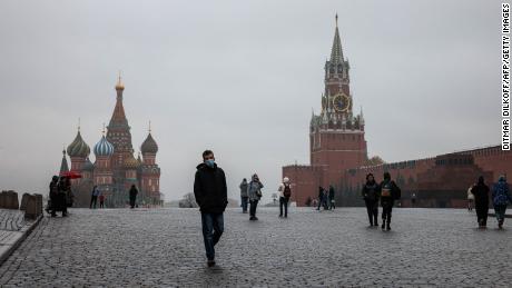 A man walks across Red Square in Moscow on Thursday, when new restrictions went into place.