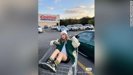 A Chinese influencer poses in the Costco parking lot in Shanghai. 