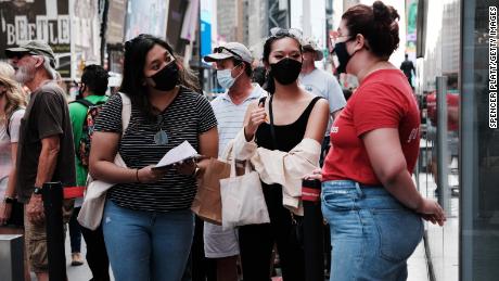 People wear masks on Broadway in New York City last month.